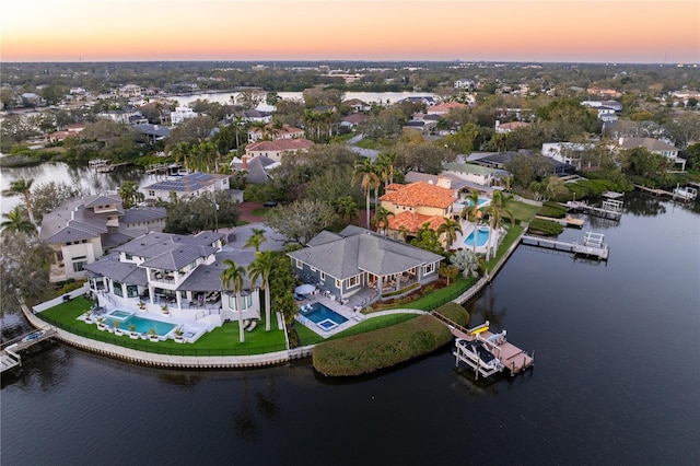 aerial view at dusk with a water view