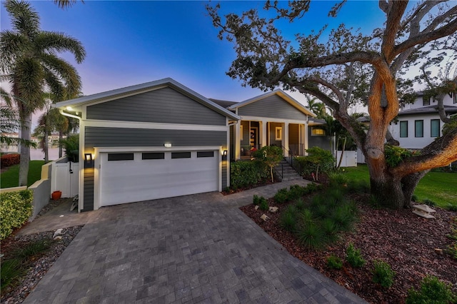 ranch-style house featuring a porch and a garage