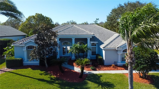 mediterranean / spanish home featuring a front yard