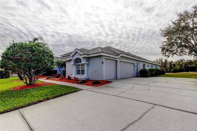 view of front of house with a garage and a front yard