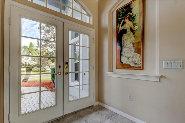 entryway with light tile patterned floors and french doors