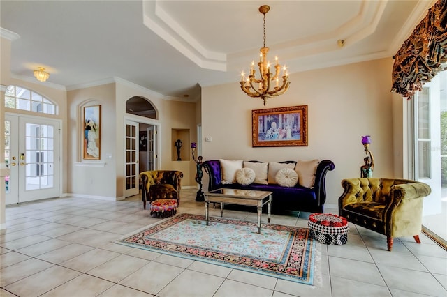 living room featuring a tray ceiling, french doors, and light tile patterned floors