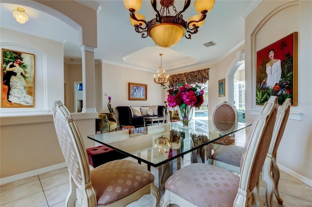 tiled dining space featuring a notable chandelier and ornamental molding