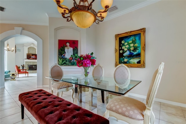 dining area with light tile patterned flooring and ornamental molding