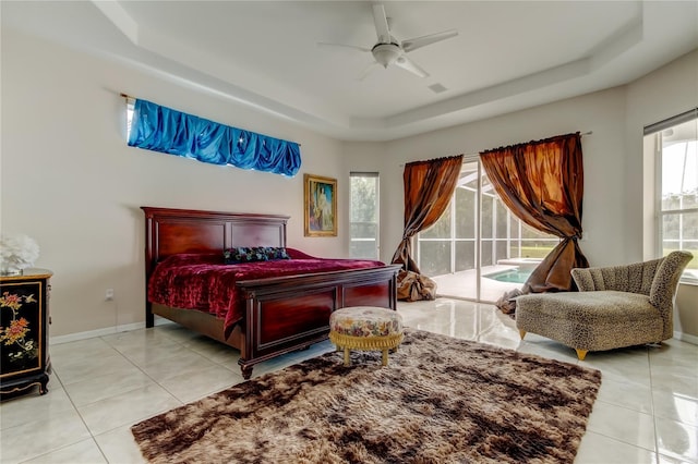 bedroom featuring access to outside, a raised ceiling, ceiling fan, and light tile patterned flooring