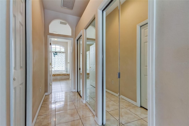 hall with light tile patterned flooring