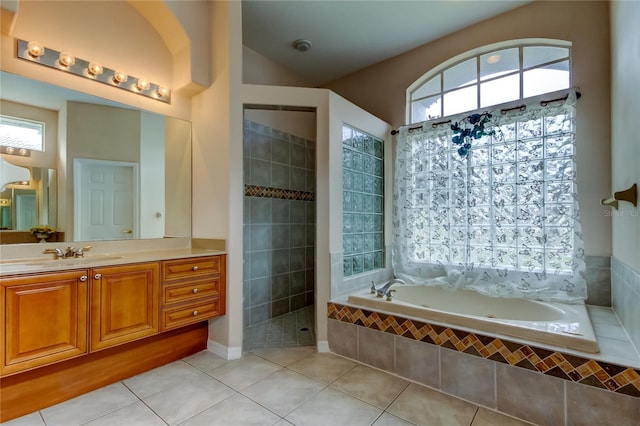 bathroom with shower with separate bathtub, vanity, and tile patterned floors