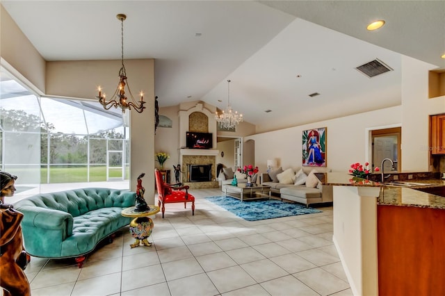 living room with a large fireplace, sink, light tile patterned floors, a notable chandelier, and lofted ceiling