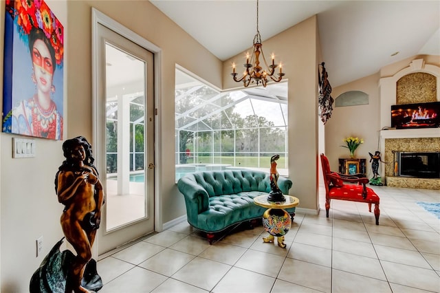 sitting room featuring a chandelier, a fireplace, a healthy amount of sunlight, and light tile patterned flooring