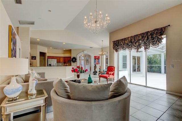 living room with light tile patterned floors, an inviting chandelier, and lofted ceiling