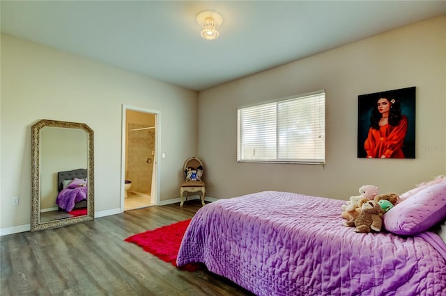 bedroom with ensuite bath and wood-type flooring