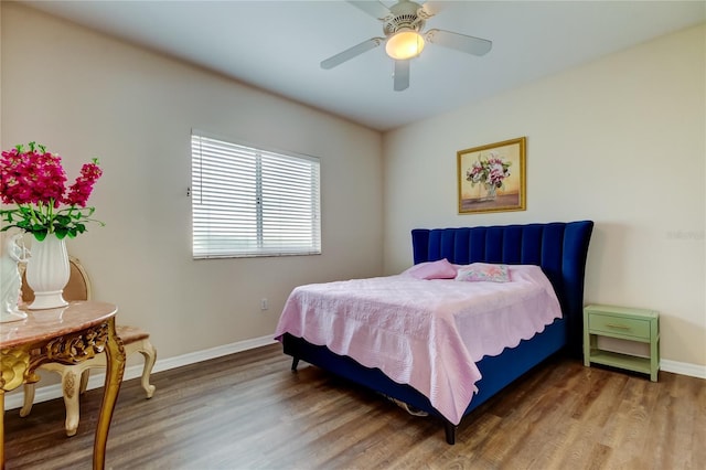 bedroom with hardwood / wood-style floors and ceiling fan