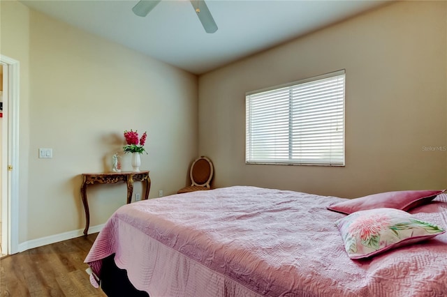 bedroom with ceiling fan and hardwood / wood-style flooring