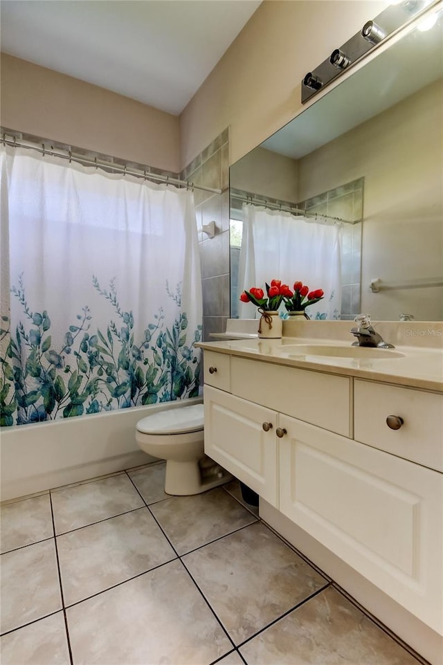 full bathroom featuring tile patterned flooring, vanity, toilet, and shower / tub combo