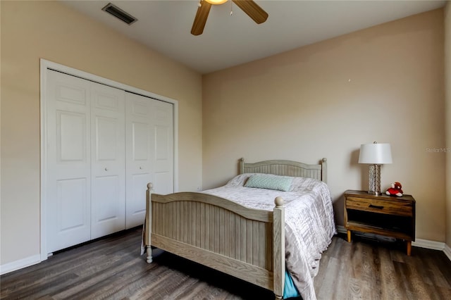 bedroom with ceiling fan, a closet, and dark hardwood / wood-style floors