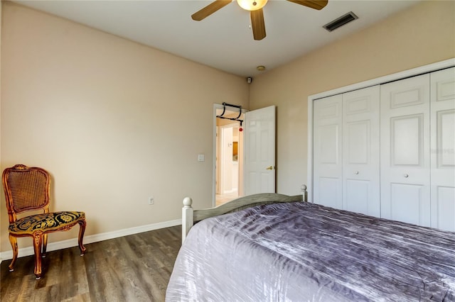 bedroom with ceiling fan, a closet, and dark wood-type flooring