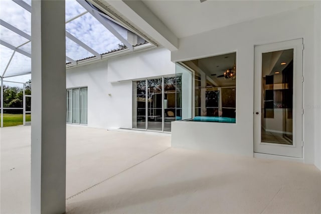 view of patio / terrace featuring glass enclosure