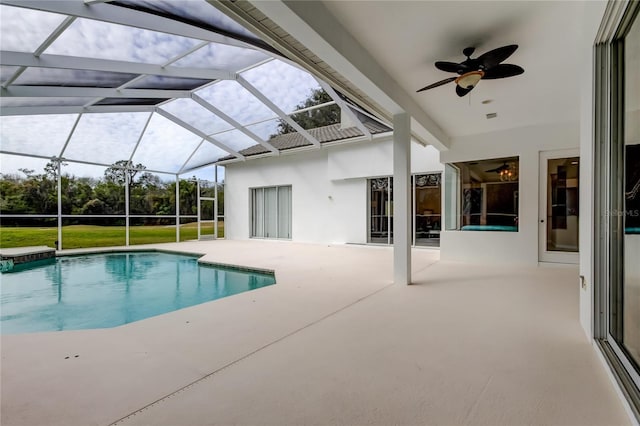 view of swimming pool featuring ceiling fan, a patio area, and a lanai