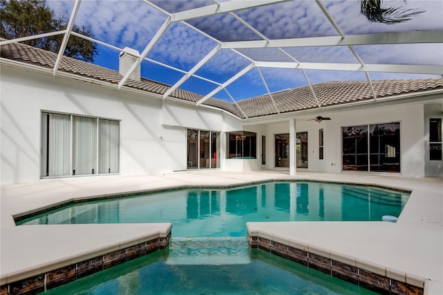 view of pool with ceiling fan, a lanai, and a patio