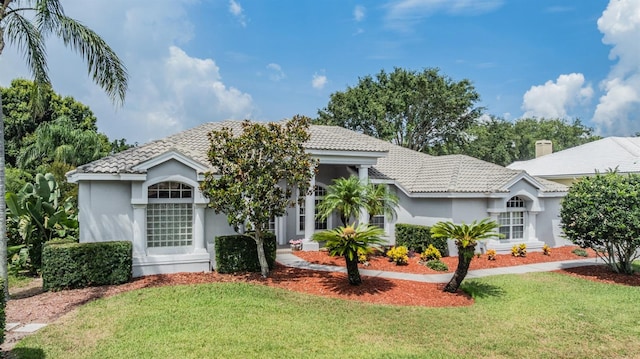 394 Tall Oak Trl, Tarpon Springs, FL 34688 - view of front of property with a front lawn, stucco siding, and a tile roof
