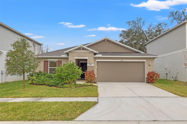 view of front of house featuring a front lawn and a garage