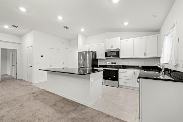 kitchen with sink, white cabinetry, appliances with stainless steel finishes, and a kitchen island