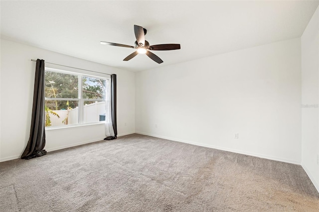 unfurnished room featuring ceiling fan and carpet floors