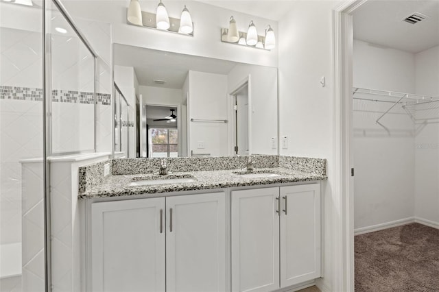 bathroom with vanity, ceiling fan, and an enclosed shower