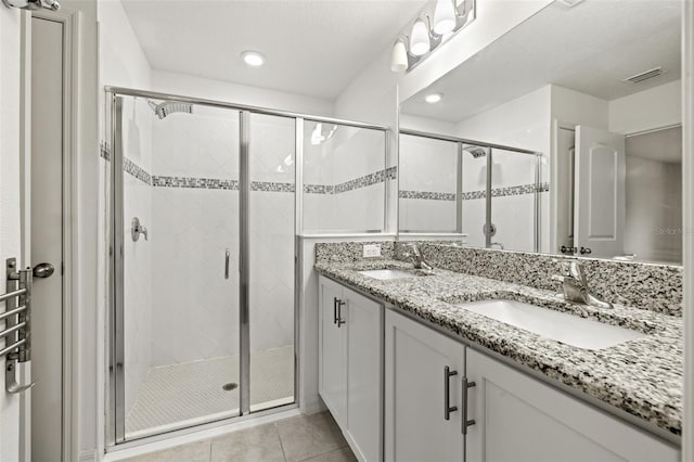 bathroom featuring an enclosed shower, vanity, and tile patterned flooring