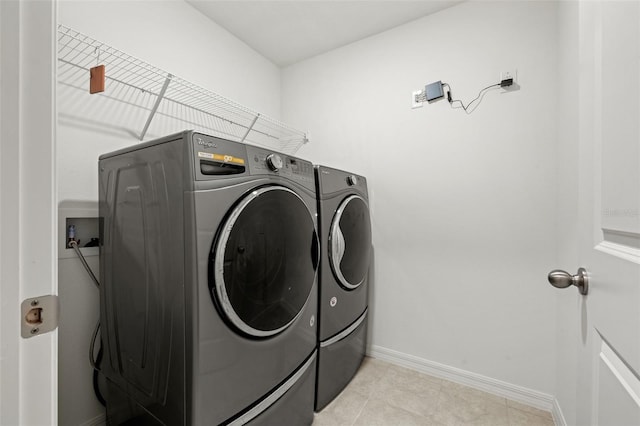 washroom featuring light tile patterned floors and washer and dryer