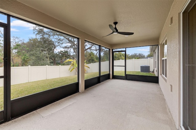 unfurnished sunroom with ceiling fan