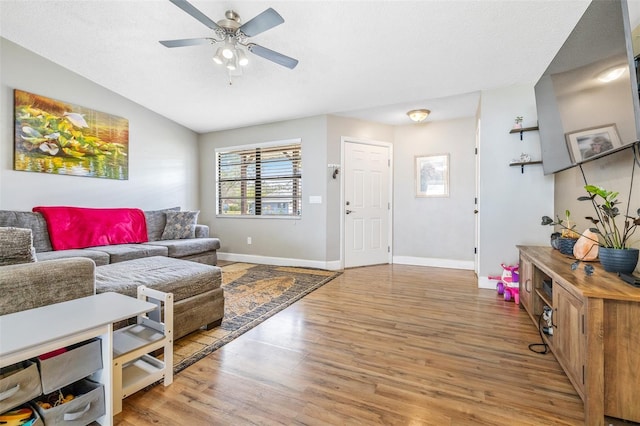 living room featuring wood-type flooring, a textured ceiling, ceiling fan, and lofted ceiling