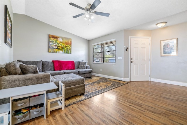 living room featuring wood-type flooring, ceiling fan, and lofted ceiling