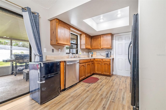 kitchen with dishwasher, refrigerator, light wood-type flooring, and sink