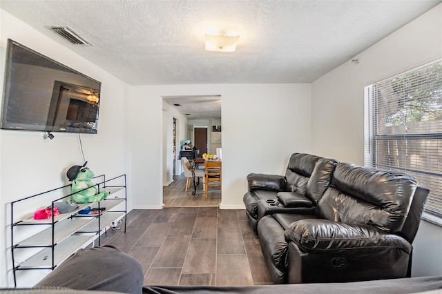 living room with a textured ceiling