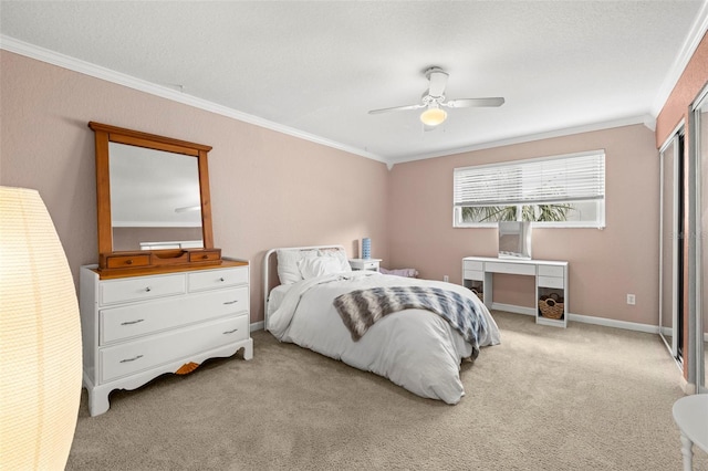 bedroom featuring ceiling fan, crown molding, and light carpet