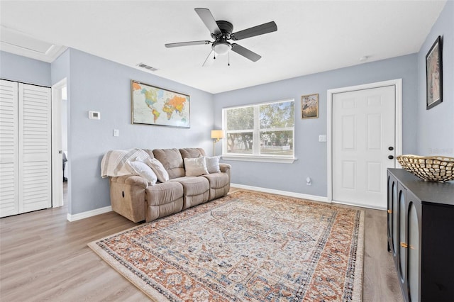 living room featuring ceiling fan and light hardwood / wood-style floors