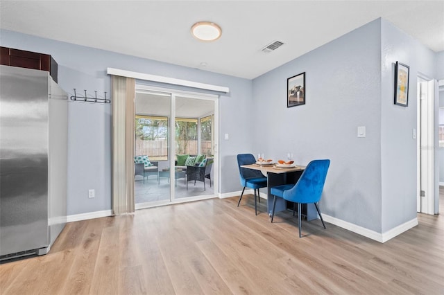 dining space with light hardwood / wood-style flooring