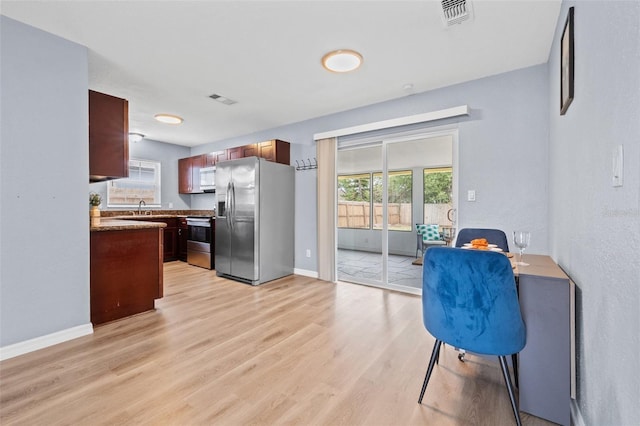 kitchen featuring light hardwood / wood-style floors, stainless steel appliances, and sink