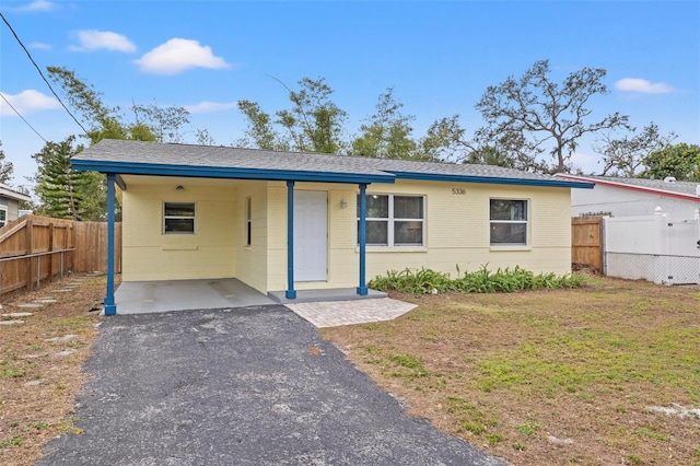 view of front of house with a front lawn and a carport