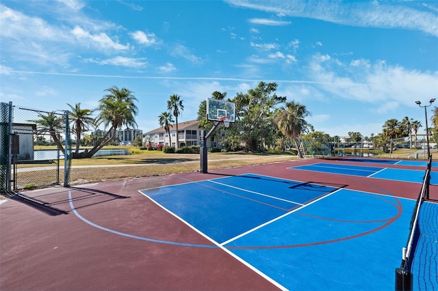 view of basketball court with community basketball court and fence