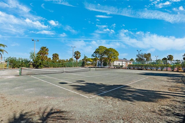 view of tennis court featuring fence