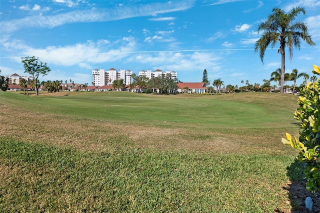 surrounding community featuring golf course view and a lawn