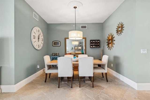 dining room featuring visible vents and baseboards