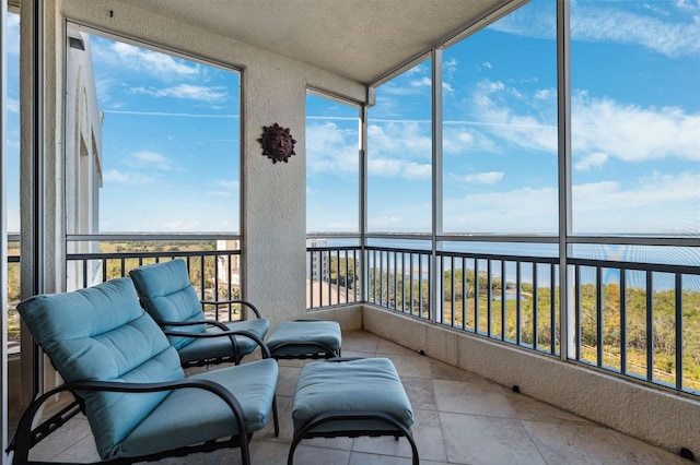 sunroom / solarium with a water view