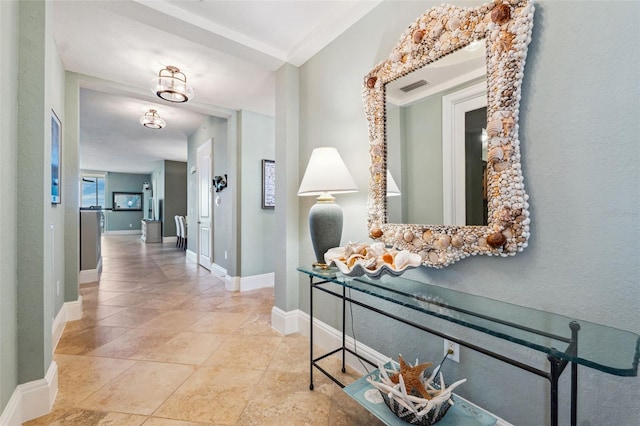 hallway with visible vents and baseboards