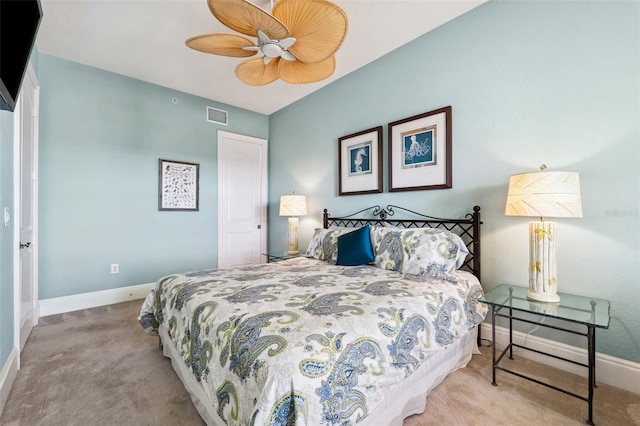 carpeted bedroom featuring baseboards, visible vents, and a ceiling fan