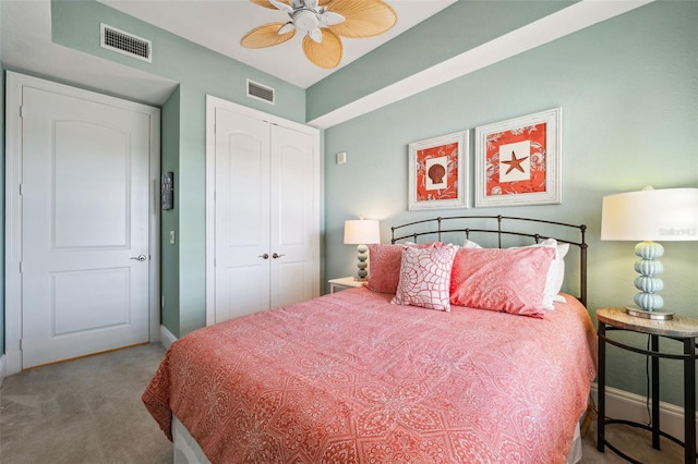 carpeted bedroom featuring a closet, visible vents, and baseboards