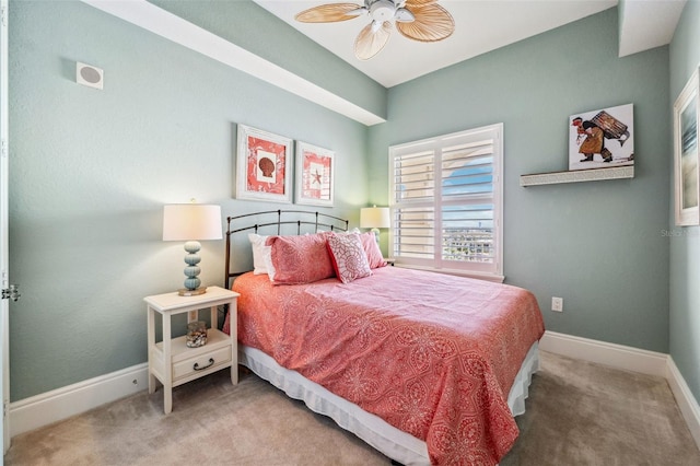 carpeted bedroom with ceiling fan and baseboards