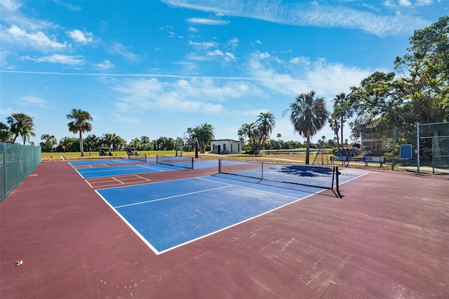 view of sport court featuring fence